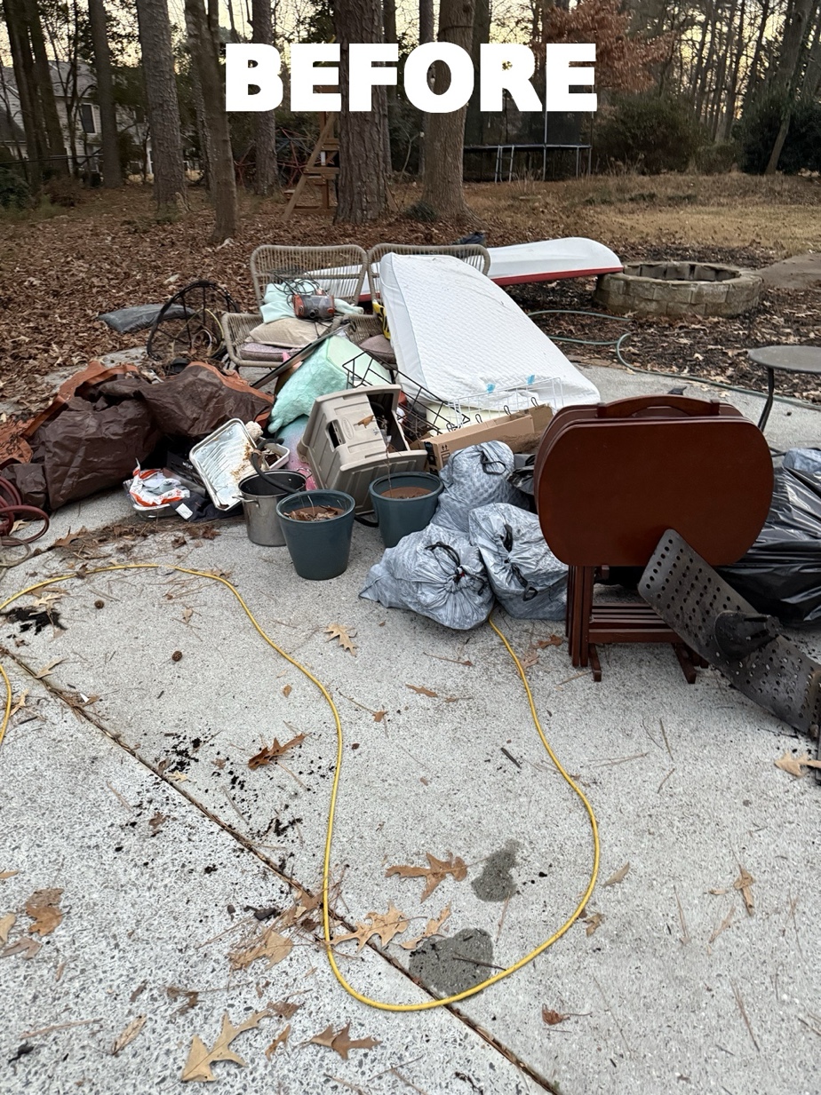 Before - backyard patio piled with furniture mattress junk